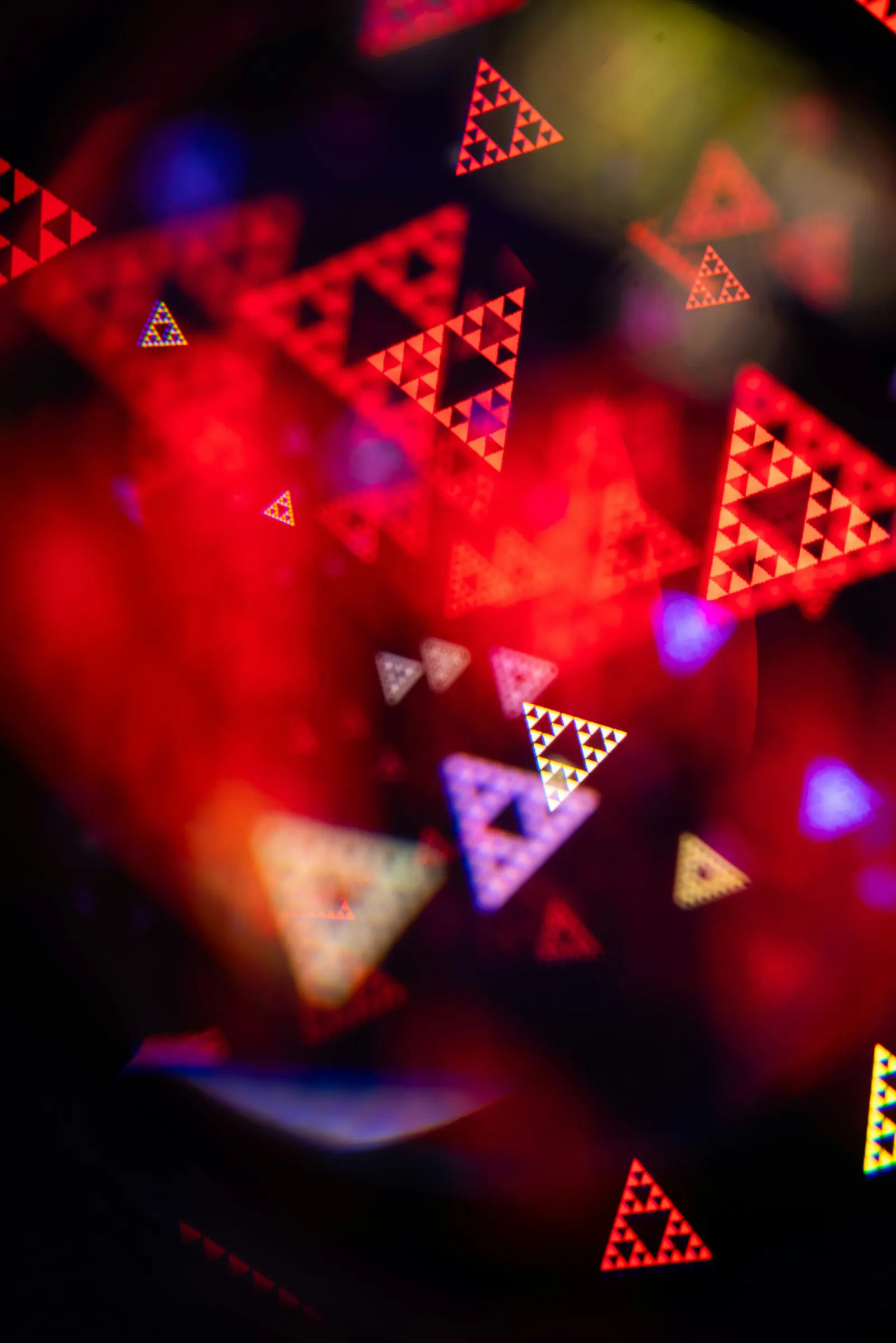 Abstract red bokeh of overlapping triangular light shapes